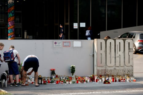 People light candles at the site of a deadly shooting at a secondary school, in Graz, Austria.