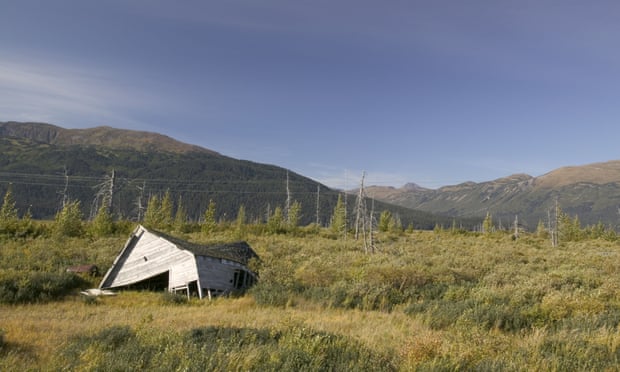 A house has collapsed into the ground as the permafrost melts beneath it, near Portage Glacier, Alaska