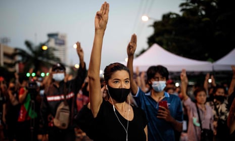 Protesters in Bangkok with arms raised