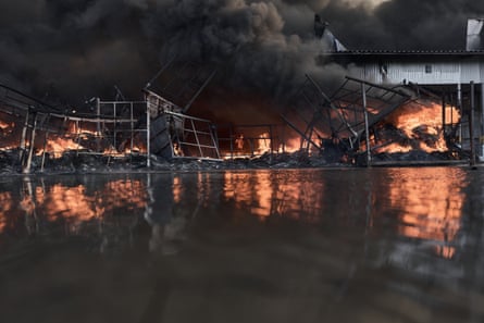 Smoke rises from a fire at a large warehouse