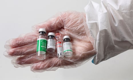 A medical worker holds vials of the AstraZeneca (India’s Covishield), Pfizer, Sputnik V and Sinopharm Covid-19 vaccines.