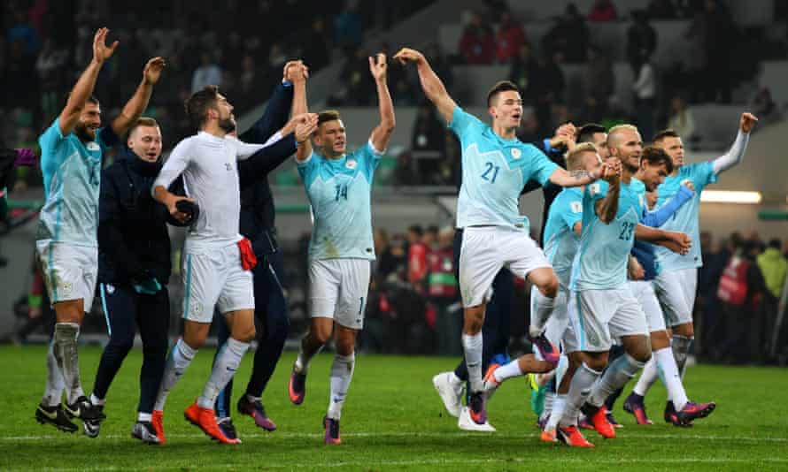 Slovenia players celebrate the draw.