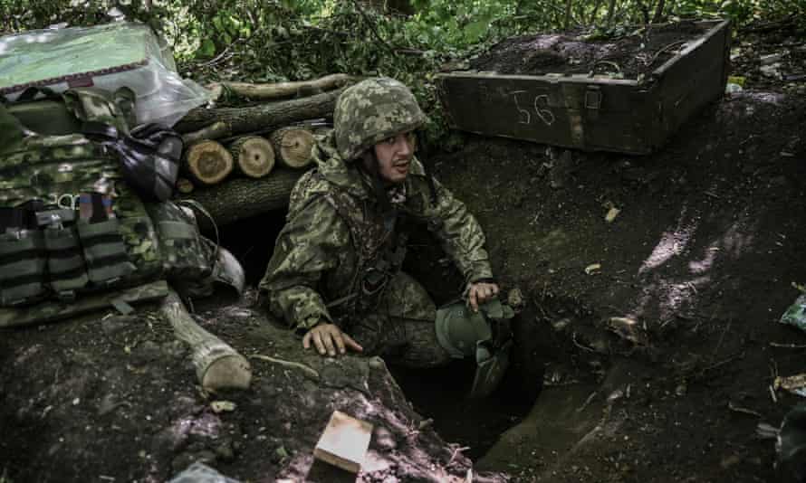 A Ukrainian serviceman shelters in an underground makeshift bunker after a shelling at a field camp near the front line in the eastern Ukrainian region of Donbas on 6 June.