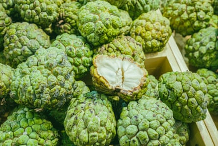 Custard apples in a wooden crate.