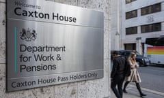 Department for Work and Pensions sign on the exterior wall of Caxton House in London, as two people walk past
