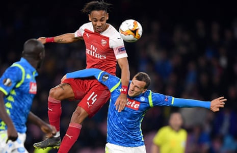 Pierre-Emerick Aubameyang of Arsenal wins a header over Vlad Chiriches of Napoli.