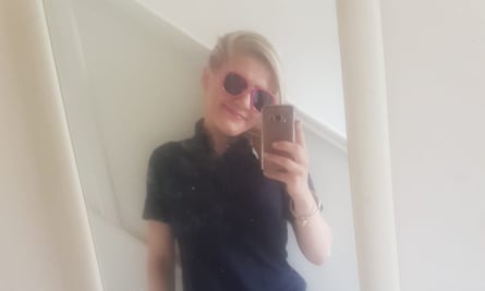 Izabela Ceckowska wearing sunglasses takes a selfie in a mirror at her home during the lockdown.
