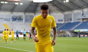 Jadon Sancho reveals his ‘Justice for George Floyd’ T-shirt after scoring the first of his goals for Borussia Dortmund at Paderborn.