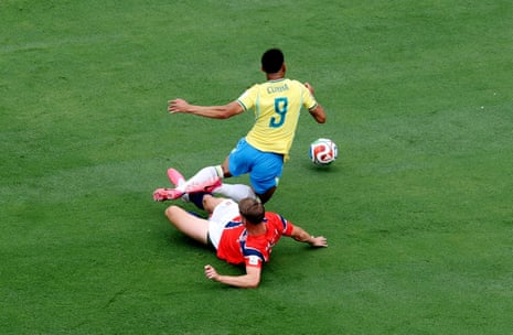 Norway's Kristoffer Ajer tackles Brazil's Matheus Cunha in the penalty area.