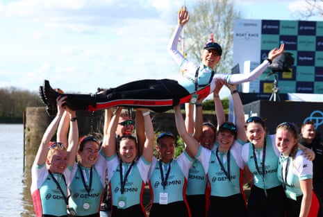 Cambridge rowers lift their cox Hannah Murphy 