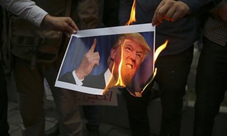 Demonstrators in Tehran burn a photograph of Donald Trump