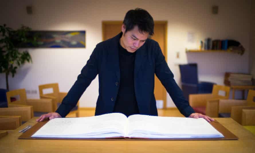 Presenter Kevin Fong looks at a book of remembrance, at St Christopher’s hospice in We Need to Talk About Death.