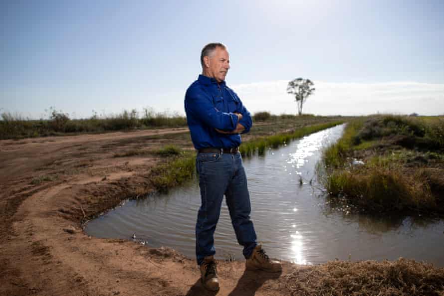Rice property owner Wayne Andreazza stands next to a body of water on his farm south of Griffith in NSW