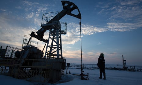 An oil worker inspects a pumping jack in an oilfield in the village of Otrada, 150km from Ufa, Russia