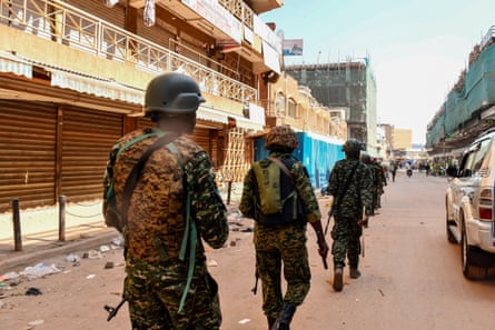 Members of the Ugandan security forces patrol in Kampala