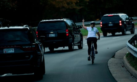 Juli Briskman gives the finger to President Donald Trump as he departs Trump National Golf Course in Sterling, Virginia.