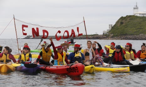 Anti-coal activists in kayaks and boats block the entrance to Newcastle harbour on Sunday. 