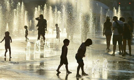 Children play in the water fountains at the Place des Arts in Montreal, Canada on 3 July 2018.