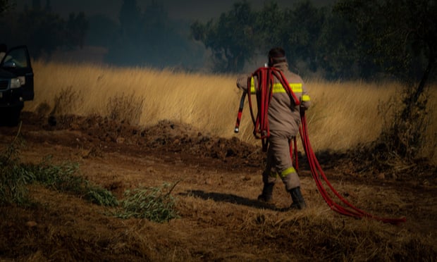 A firefighter battles wildfire near Athens in August.