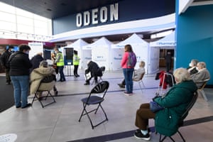 People wait to receive the Oxford/AstraZeneca vaccine at the opening of the first Pharmacy2U Covid-19 vaccination centre at the Odeon Cinema in Aylesbury on 21 January, 2021