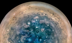 Jupiter's south pole shows turbulence in the clouds.