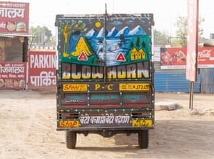 The back of a truck covered in slogans, including ‘Blow horn’ in large text