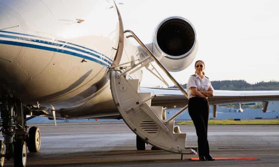 Pilot standing with executive jet