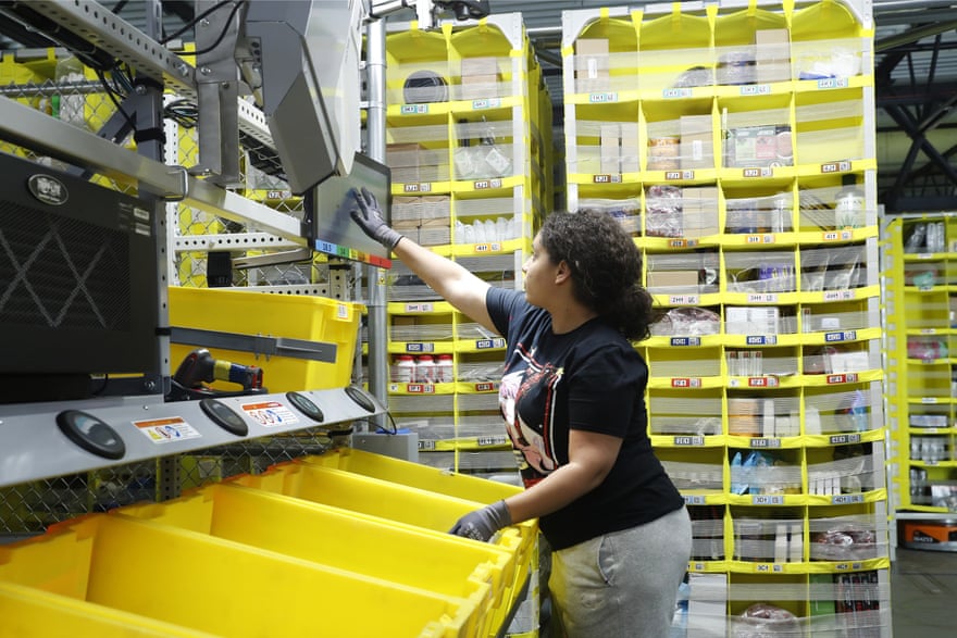 A worker sorts through items and places orders at the Amazon fulfillment center on Staten Island.