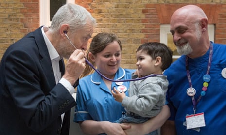 Labour leader Jeremy Corbyn pretends to use a stethoscope with 2-year-old Haroon, after he met NHS nurses, student nurses and midwives at Unison HQ.