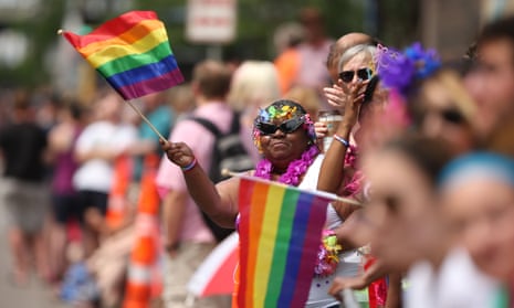 A woman waves a rainbow flag during a gay pride parade in Minneapolis. Estimates place the city’s LGBTQ population at more than 10%.