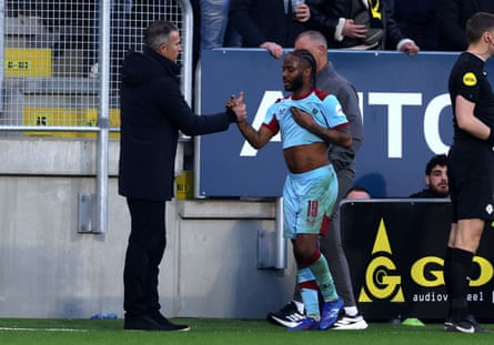 Robin van Persie and Raheem Sterling clasp hands pitchside