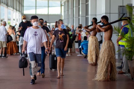 Traditional dancers in grass skirts welcome holidaymakers in Nadi, Fiji