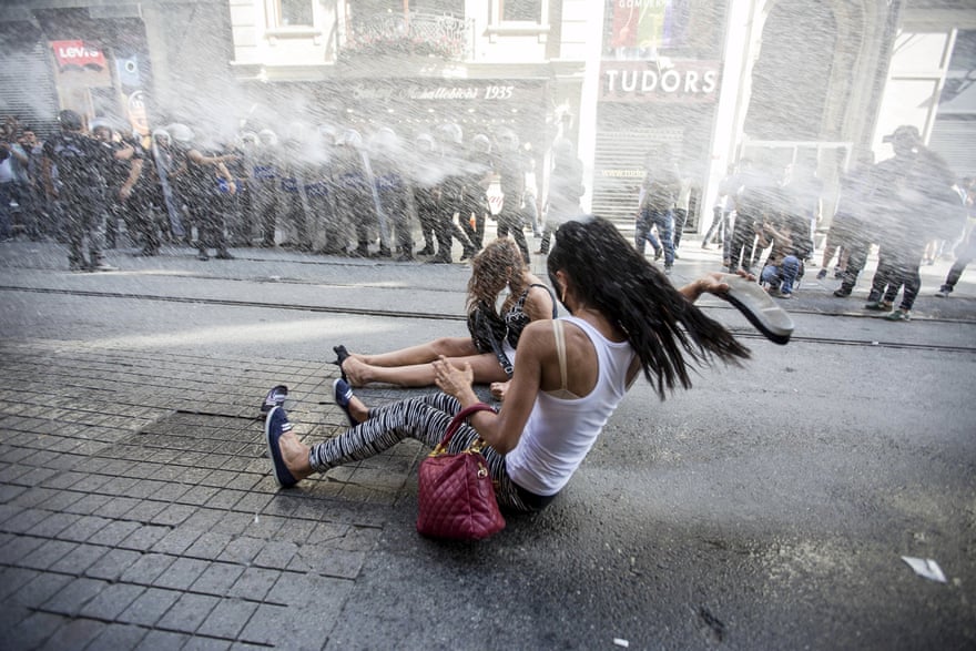 Riot police use a water cannon to disperse LGBT rights activist before a Gay Pride Parade in central Istanbul, Turkey.