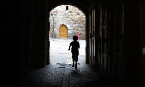A child walks on an empty street in the old city of the West Bank town of Hebron, 31 May.