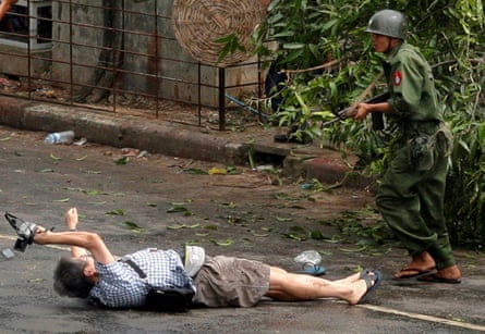 An injured Kenji Nagai tries to take photographs after security forces fired on protesters in Yangon in 2007.