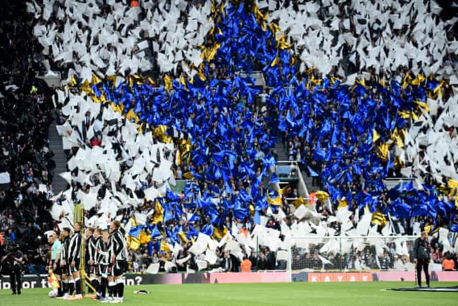 Newcastle fans throw their tifo as the players line up before kick-off.