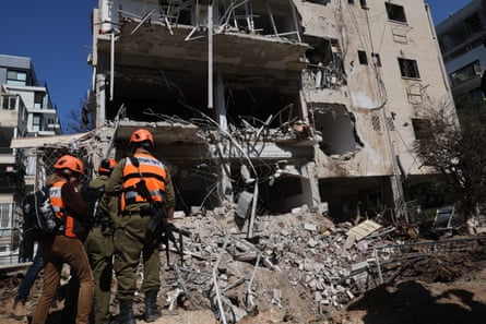 Israeli emergency service personnel at the site of a destroyed building