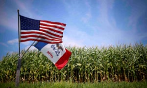 A US and Iowa state flags are seen next to a corn field in Grand Mound, Iowa, United States,
