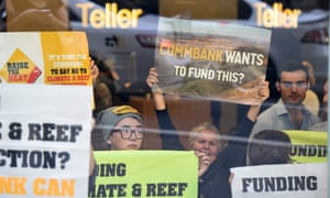 Protesters from 350.org perform a sit-in at the Commonwealth Bank on the corner of Market and George Streets in Sydney, 21 May 2015.