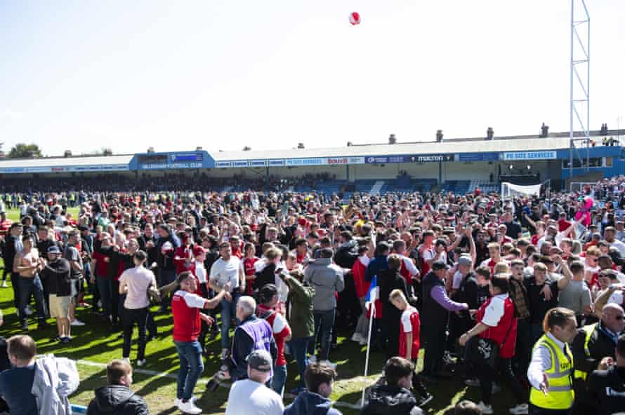 Rotherham fans on the ground at Priestfield after winning promotion.