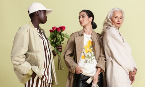Models wearing green bomber jacket, trench coat, and cream wool coat