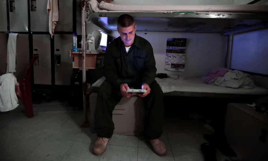 An inmate in New Hampshire state prison for men reads a tablet
