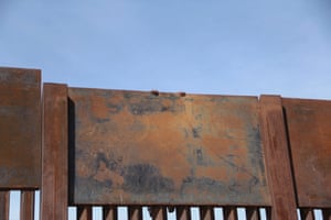 A Mexican migrant climbs the metal wall that divides the border between Mexico and the United States to cross illegally to Sunland Park from Ciudad Juarez.
