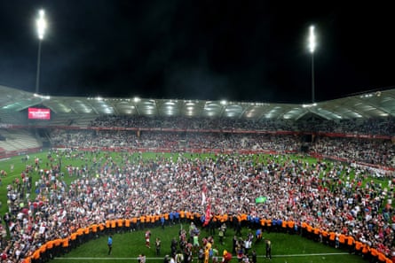 Reims’ supporters celebrate after Stade de Reims won promotion to the Ligue 1 on 20 April 2018 at the Auguste Delaune Stadium.