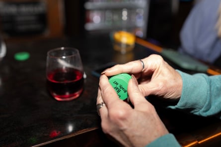 close up of a pair of hands holding green chips