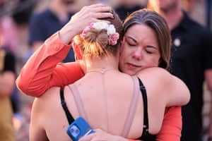 Two women embrace