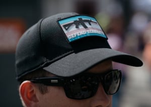 A John Brown Gun Club member wears a patch featuring the Trans Pride flag and an AR-15 while community defending Trans Pride in Seattle.