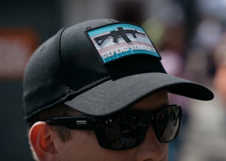 A John Brown Gun Club member wears a patch featuring the Trans Pride flag and an AR-15 while community defending Trans Pride in Seattle.