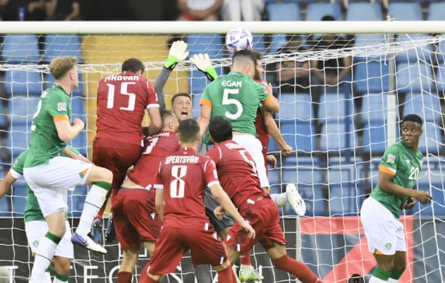 Ireland’s and Armenia’s players challenge for the ball.