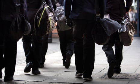 Pupils walk between classrooms at a secondary school in England.